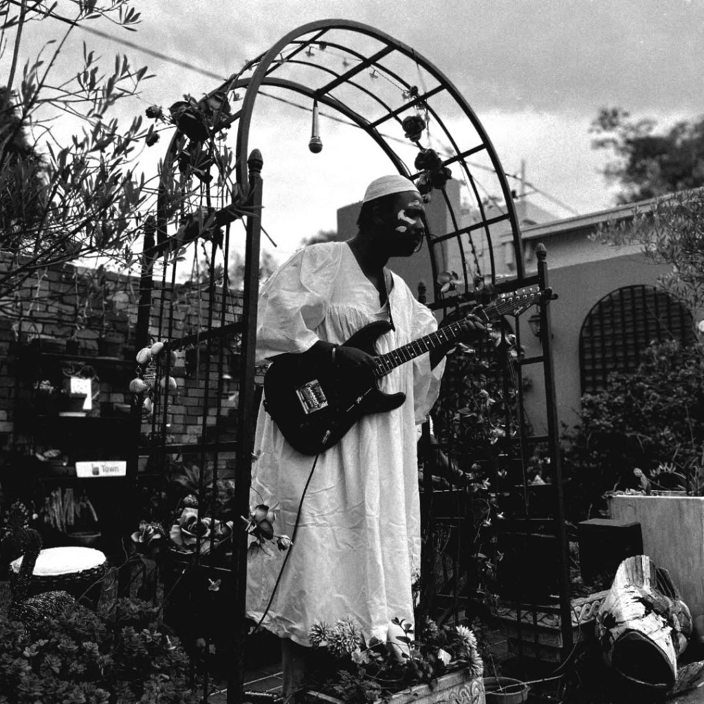 Safe Energy playing guitar and singing at a listening session at Wild Jasmin